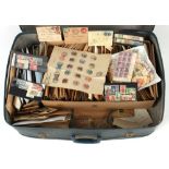 Stamps - World: A large suitcase with stamps sorted into envelopes and loose. (Viewing recommended).