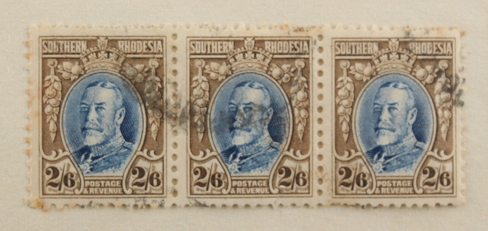 Stamps - World: A mixed lot in a carton including Southern Rhodesia 1931-37 2/6d. strip of three