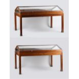 A pair of mahogany museum display cases, double sided, with hinged sloping tops, on loose stands,