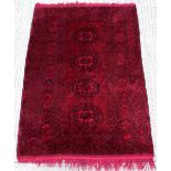 Property of a lady - an Afghan rug, 83 by 55ins. (211 by 140cms.).