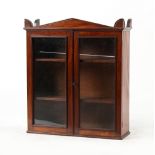 Property of a lady - an early 19th century Regency period mahogany glazed two-door wall cabinet,