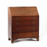 Property of a lady - a George III oak & mahogany banded fall-front bureau, 38ins. (96.5cms.) wide (