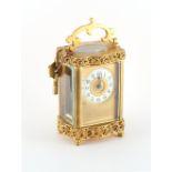 Property of a lady - a late 19th / early 20th century French brass serpentine sided carriage clock