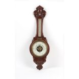 Property of a deceased estate - a late 19th / early 20th century carved walnut cased aneroid