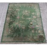 Property of a lady - a Chinese wool carpet, first half 20th century, with green ground, old moth