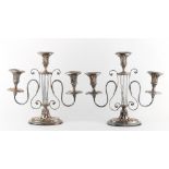 Property of a lady of title - a pair of early 20th century silver plated three light candelabra of