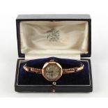 Property of a gentleman - a lady's 9ct gold cased mechanical wristwatch on elasticated 9ct gold link