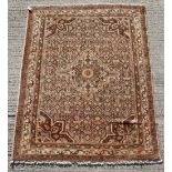 A Hamadan woollen hand-made rug with beige ground, 78 by 61ins. (199 by 155cms.).