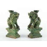 Property of a gentleman - a pair of Chinese green glazed pottery temple lion joss stick holders,