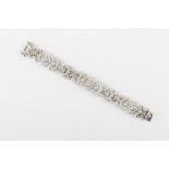 A good 18ct white gold diamond link bracelet, the mixed round cut & baguette cut diamonds