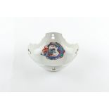 A Japanese kakiemon dish, 18th century, with shaped & pierced rim, painted with a coiled dragon, 5.