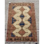 A Shiraz woollen hand-made rug with cream ground, 74 by 50ins. (189 by 127cms.).