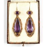 A good pair of Georgian cannetille & amethyst pendant earrings, each with a large pear shaped cut