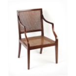 Property of a lady of title - an Edwardian cane panelled open armchair, with square tapering front