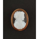 An unmarked yellow gold oval framed hardstone cameo brooch, carved with the head of a classical