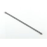 An attractive 18ct white gold sapphire & diamond three strand bracelet, 7.65ins. (19.5cms.) long.