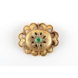 A Victorian unmarked yellow gold (tests 14/15ct) emerald & diamond oval brooch, the rectangular