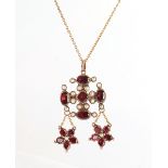 A Victorian unmarked yellow gold garnet & seed pearl pendant brooch, the closed back engraved '