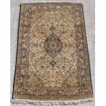 Property of a gentleman - a Persian silk rug with cream ground, 84 by 55ins. (213 by 140cms.).