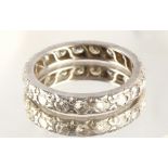 A platinum or white gold diamond eternity ring, set with nineteen round brilliant cut diamonds, size