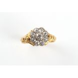 An unmarked 19th century yellow gold diamond cluster ring, with nine old cut diamonds between chased