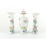 A garniture of three Chinese famille rose vases, Yongzheng period (1723-35), each painted with