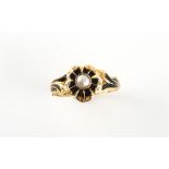 A Victorian unmarked yellow gold black enamel & pearl mourning ring, of floral form, with engraved