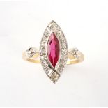 An early 20th century yellow gold ruby & diamond ring, the marquise cut ruby weighing an estimated