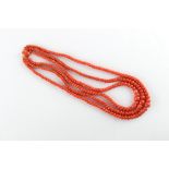 A good graduated coral bead three strand necklace, the 18ct yellow gold clasp set with a larger oval