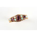 A late Georgian 18ct yellow gold amethyst & opal ring, the setting with scroll decorations to the