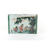 A large Chinese famille verte brick pillow, painted with a family in gardens, the reverse with a