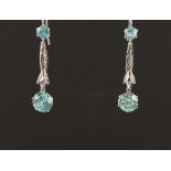 A pair of unmarked white gold (tests 14ct) zircon pendant earrings, for pierced ears, each with