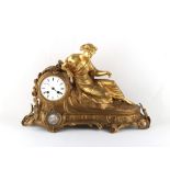 Property of a lady - a late 19th century French gilt metal figural mantel clock, with inset oval