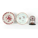 Two 18th century Chinese famille rose plates, the larger 12.4ins. (31.5cms.) diameter; together with