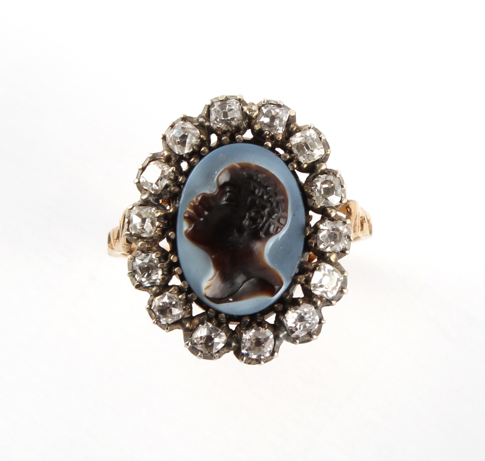 A 19th century unmarked yellow gold diamond & hardstone oval cameo ring, carved with a blackamoor or