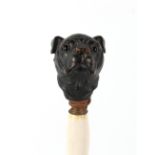 The Henry & Tricia Byrom Collection - an umbrella with carved wood dog's head terminal.