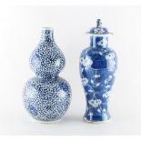 A Chinese blue & white double gourd vase, 11.5ins. (29.2cms.) high; together with a damaged blue &