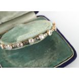 An attractive diamond bracelet set with eight Old European cut diamonds in millegrain collets, the