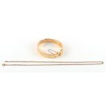 A 9ct gold hinged bangle; together with a 9ct gold chain necklace (approximately 19.8 grams