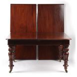 An early 19th century William IV mahogany extending dining table, with two extra leaves, on tulip