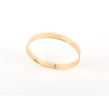 A yellow gold (tests 9ct) bangle, inner diameter approximately 79mm, approximately 48.5 grams.