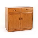 Property of a deceased estate - an Ercol elm side cabinet with two drawers above two panelled doors,