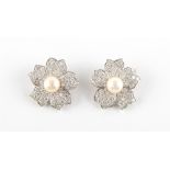 A pair of diamond & pearl flowerhead cluster earrings, with clip fastenings, each with a central