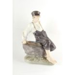 Property of a lady - a large Royal Copenhagen figure of a boy sitting on a rock, model number