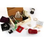 A cream coloured jewellery box containing assorted costume jewellery.