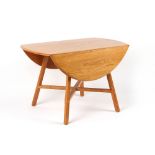 Property of a lady - an Ercol light elm drop-leaf dining table with chamfered legs united by cross