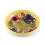 Property of a lady - a Moorcroft anemone pattern shallow bowl with yellow ground, impressed