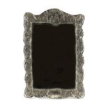 Property of a gentleman - a large silver framed easel dressing table mirror, with repousse