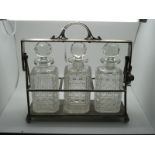 A JD&S Electroplated Three Bottle Locking Tantalus, of plain design, with three hobnail cut glass