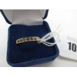 A 9ct Gold "Dearest" Ring, claw set with seven uniform stones (finger size P) (2g).